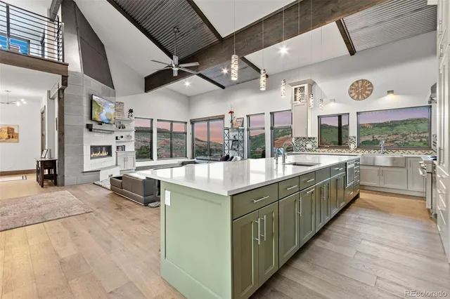 a kitchen with stainless steel appliances granite countertop a sink and cabinets