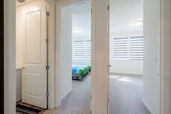 an aerial view of a city with lots of residential buildings and ocean view