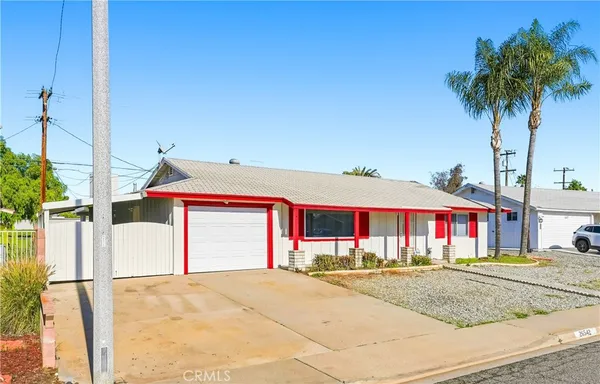 a front view of house with yard and trees