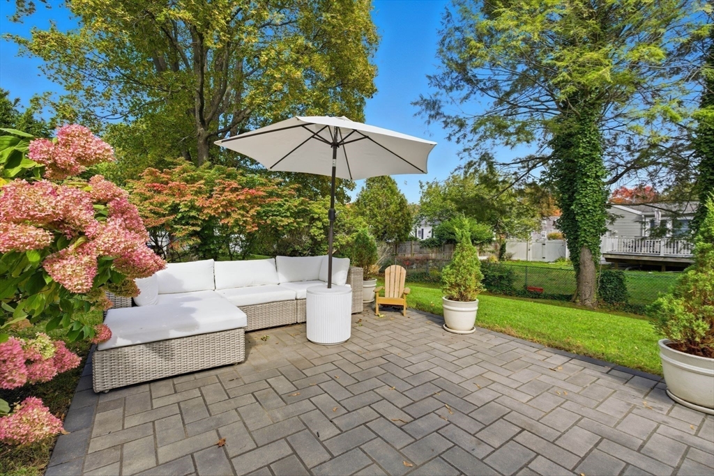 16 Beebe Lane Wakefield, MA 01880 - Photo 26 of 32 a view of a patio with dining table and chairs under an umbrella