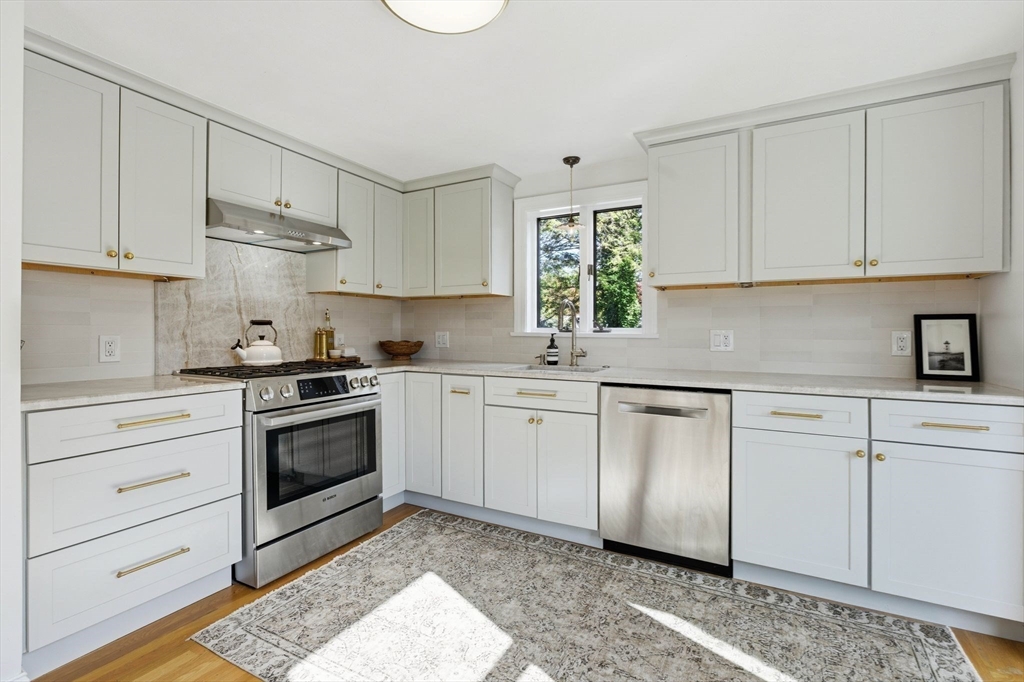 16 Beebe Lane Wakefield, MA 01880 - Photo 6 of 32 a kitchen with granite countertop white cabinets and white appliances