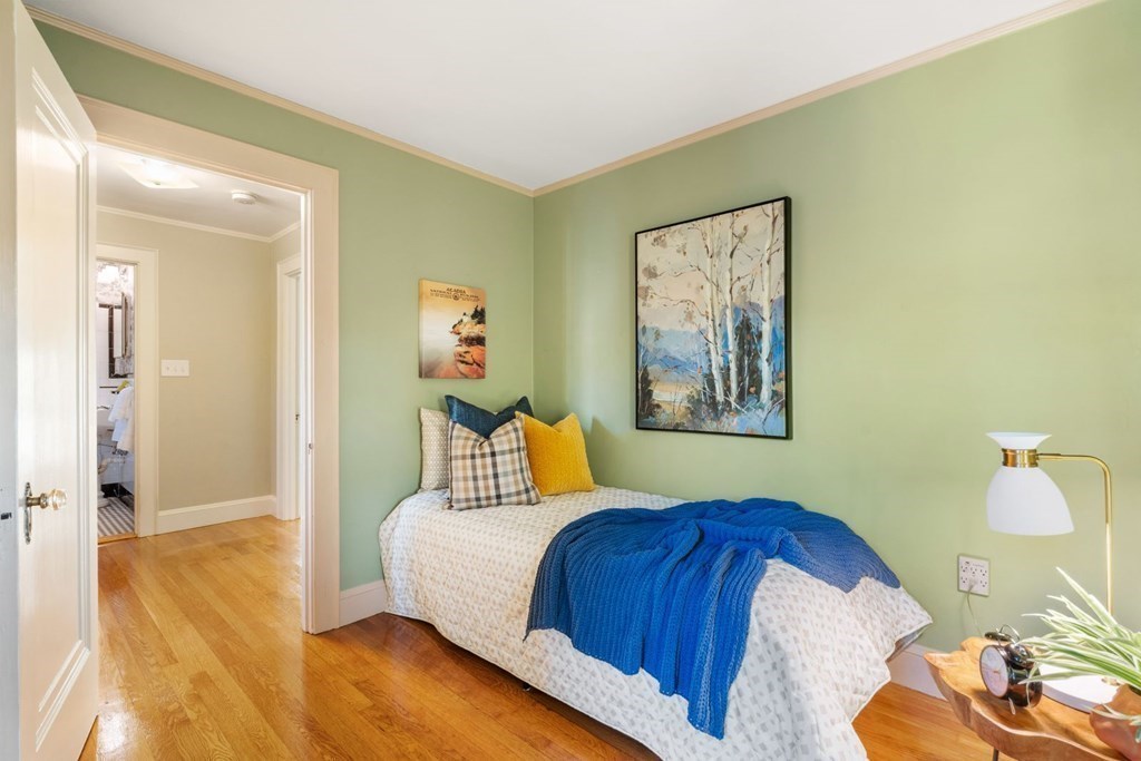 21 Laird Road Medford, MA 02155 - Photo 21 of 32 a bedroom with a bed and wooden floor