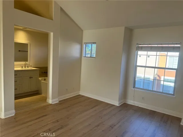a view of wooden floor and windows in a room
