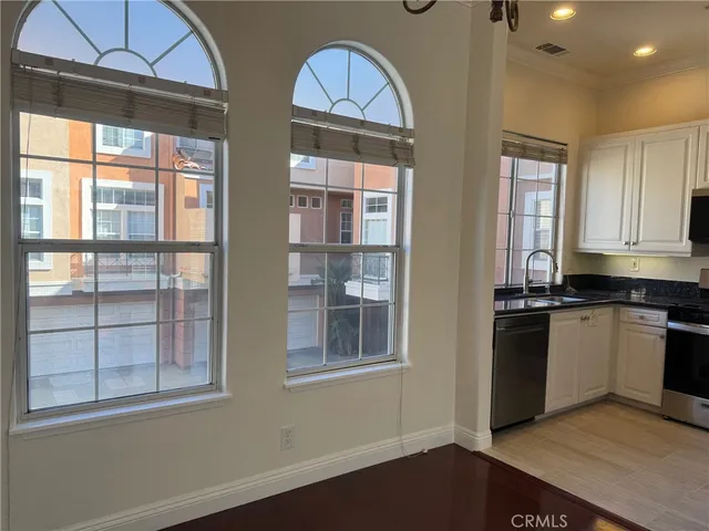 a kitchen with windows and refrigerator