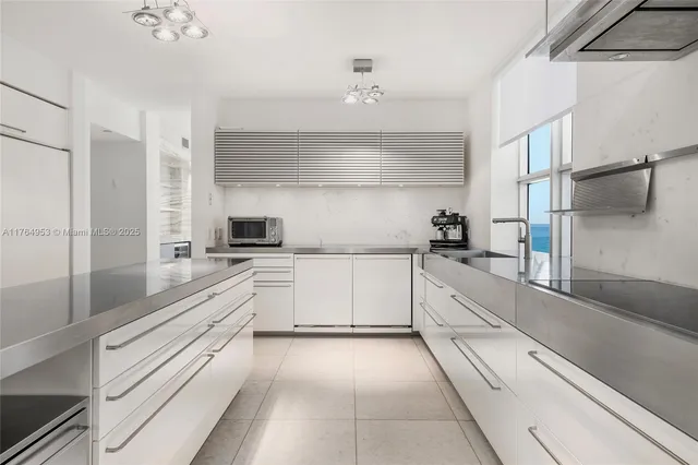a large white kitchen with cabinets