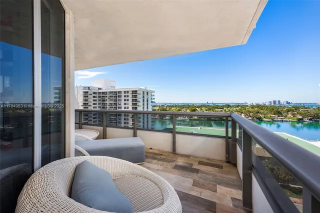 a bedroom with a bed chandelier and a window