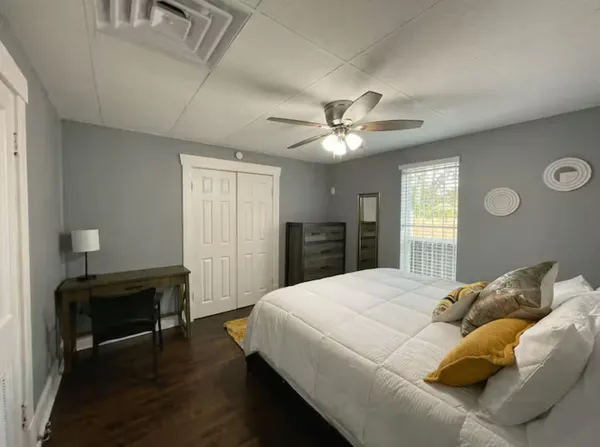 a bedroom with a bed and a chandelier