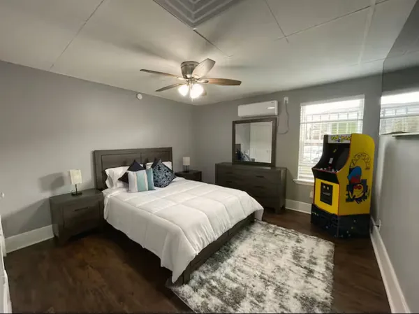a bedroom with a bed and a chandelier