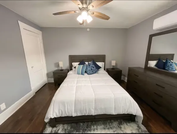 a bedroom with a bed and a mirror