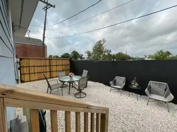 a roof deck with table and chairs