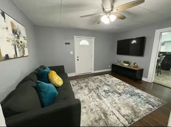 a living room with furniture and a flat screen tv