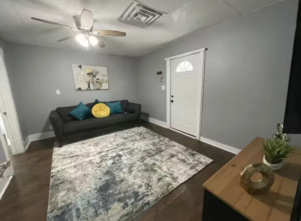 a living room with a couch and chandelier