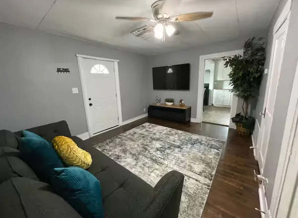 a living room with furniture and a flat screen tv