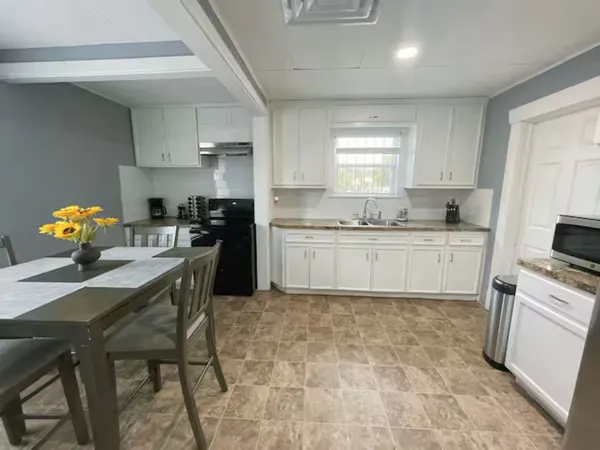 a kitchen with a sink cabinets and window