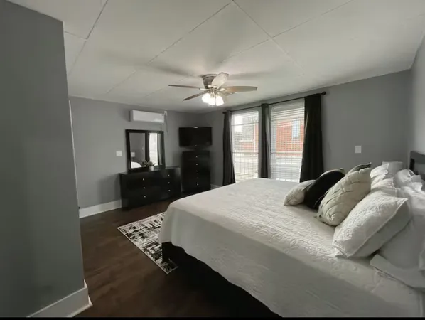 a bedroom with a large bed and a chandelier