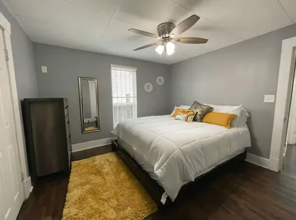 a bedroom with a bed and a chandelier
