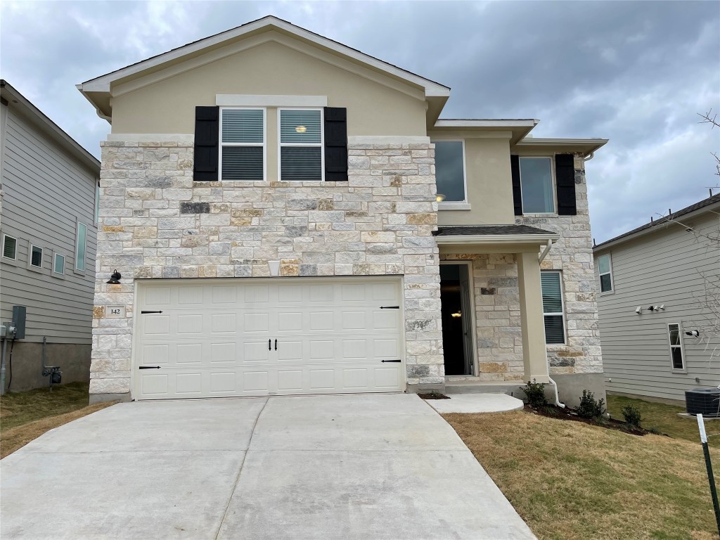 a front view of a house with garage