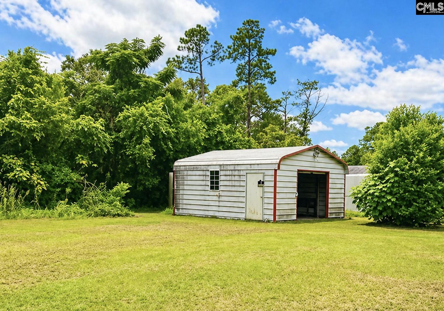 118 State Rd S-38-1224 Cordova, SC 29039 - Photo 12 of 12 a front view of a house with a garden