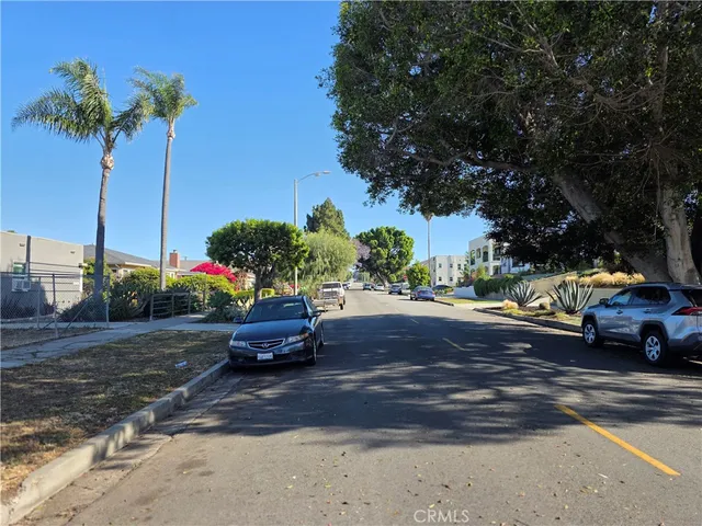 a view of a street with cars on road