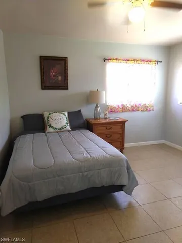 a bedroom with bed and window