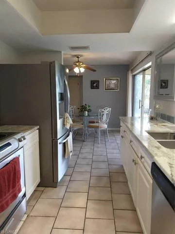 a living room with granite countertop furniture a dining table and a potted plant