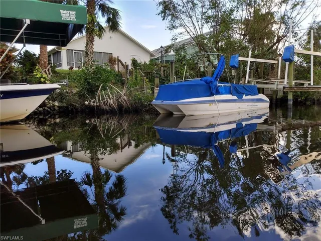 a view of a chairs and table in backyard