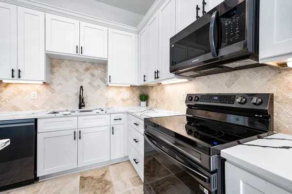 a kitchen with cabinets appliances and a sink