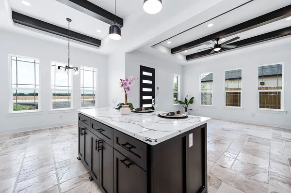 a kitchen with a table and chairs