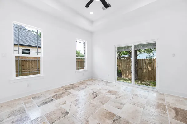 a view of an empty room with window and bathroom