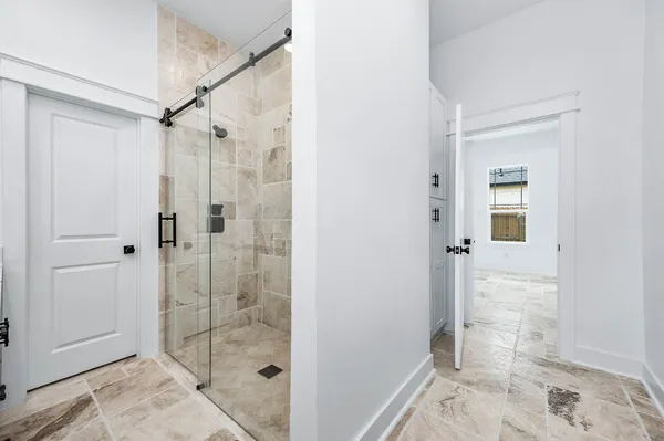 a bathroom with a shower and a sink