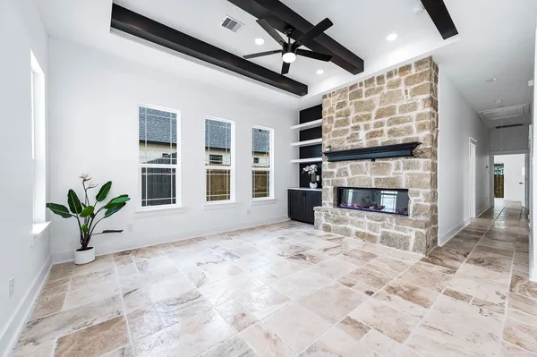 a view of living room with furniture and a fireplace