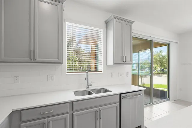 a kitchen with a sink and cabinets