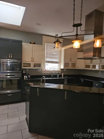 a kitchen with a sink a stove and cabinets