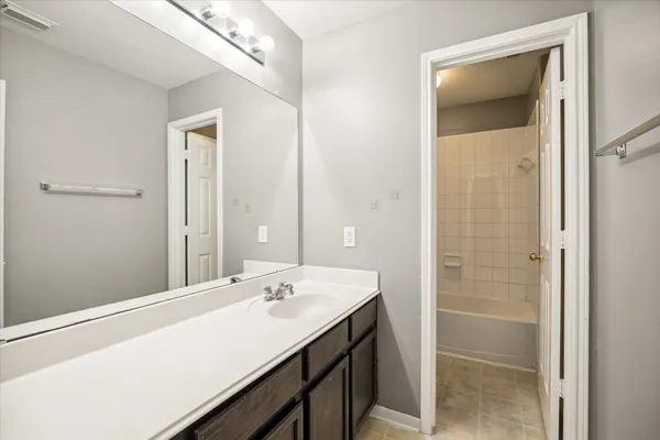 a bathroom with a sink a mirror and a shower