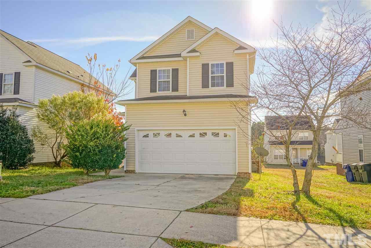 4232 Beacon Crest Way Raleigh, NC 27604 - Photo 2 of 25 a front view of a house with a yard and garage
