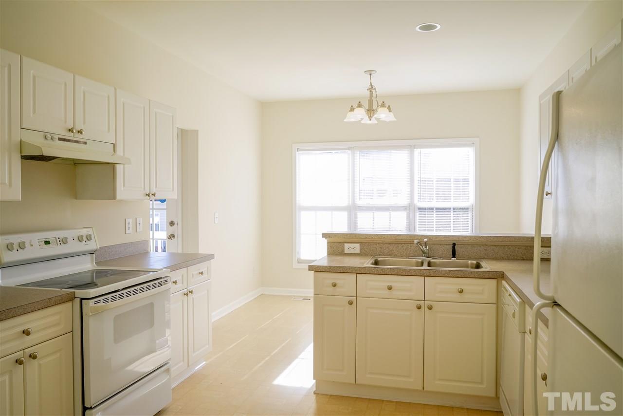 4232 Beacon Crest Way Raleigh, NC 27604 - Photo 11 of 25 a kitchen with stainless steel appliances granite countertop a sink stove and cabinets