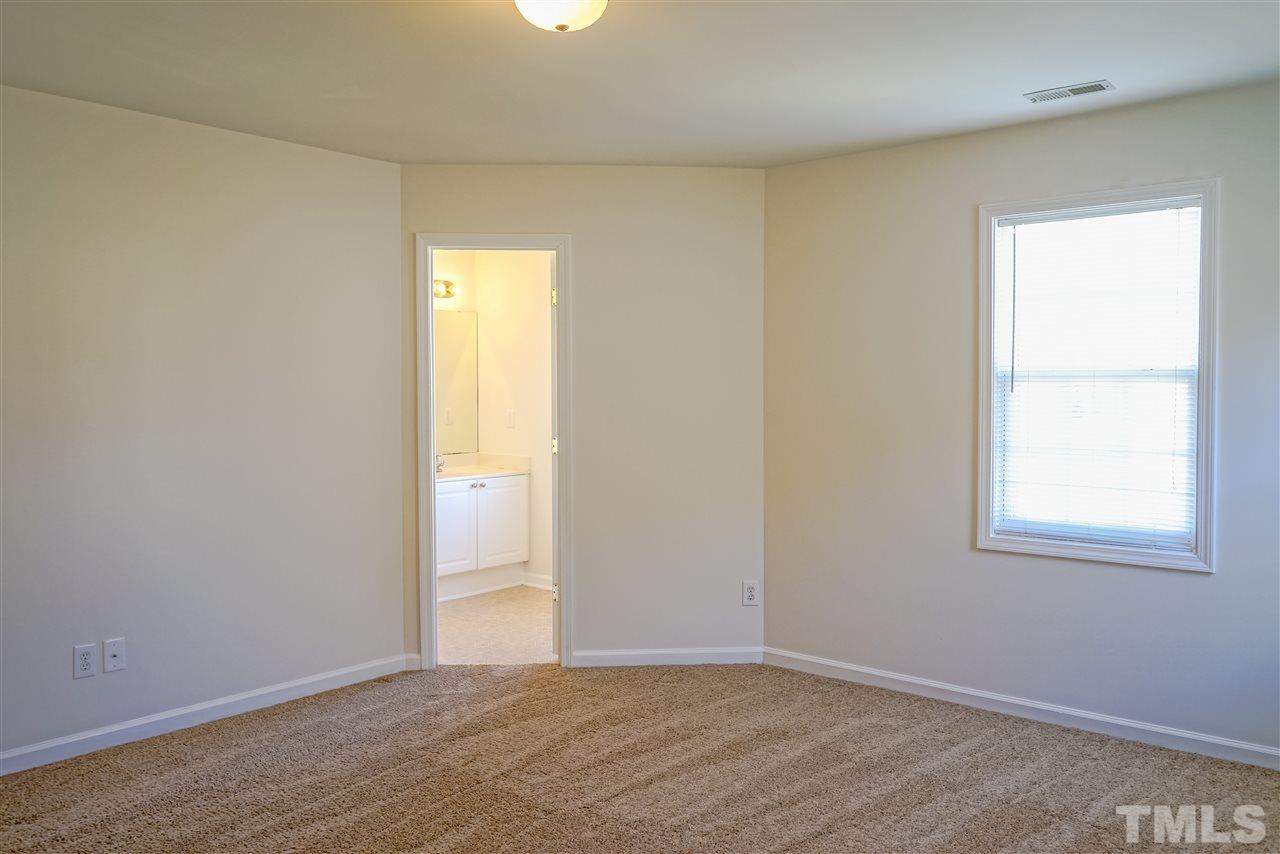 4232 Beacon Crest Way Raleigh, NC 27604 - Photo 16 of 25 an empty room with wooden floor and windows