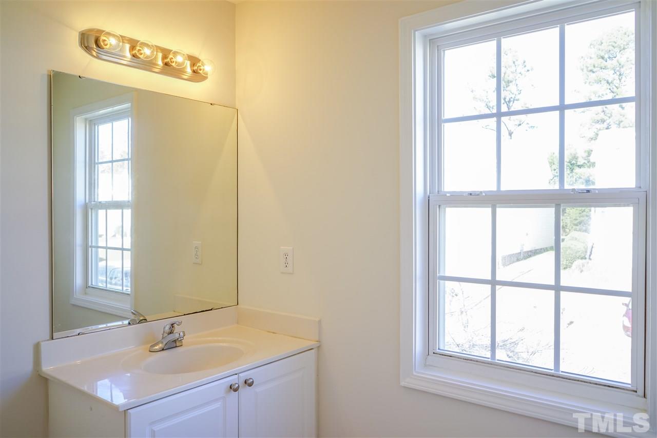 4232 Beacon Crest Way Raleigh, NC 27604 - Photo 18 of 25 a bathroom with a sink and a window