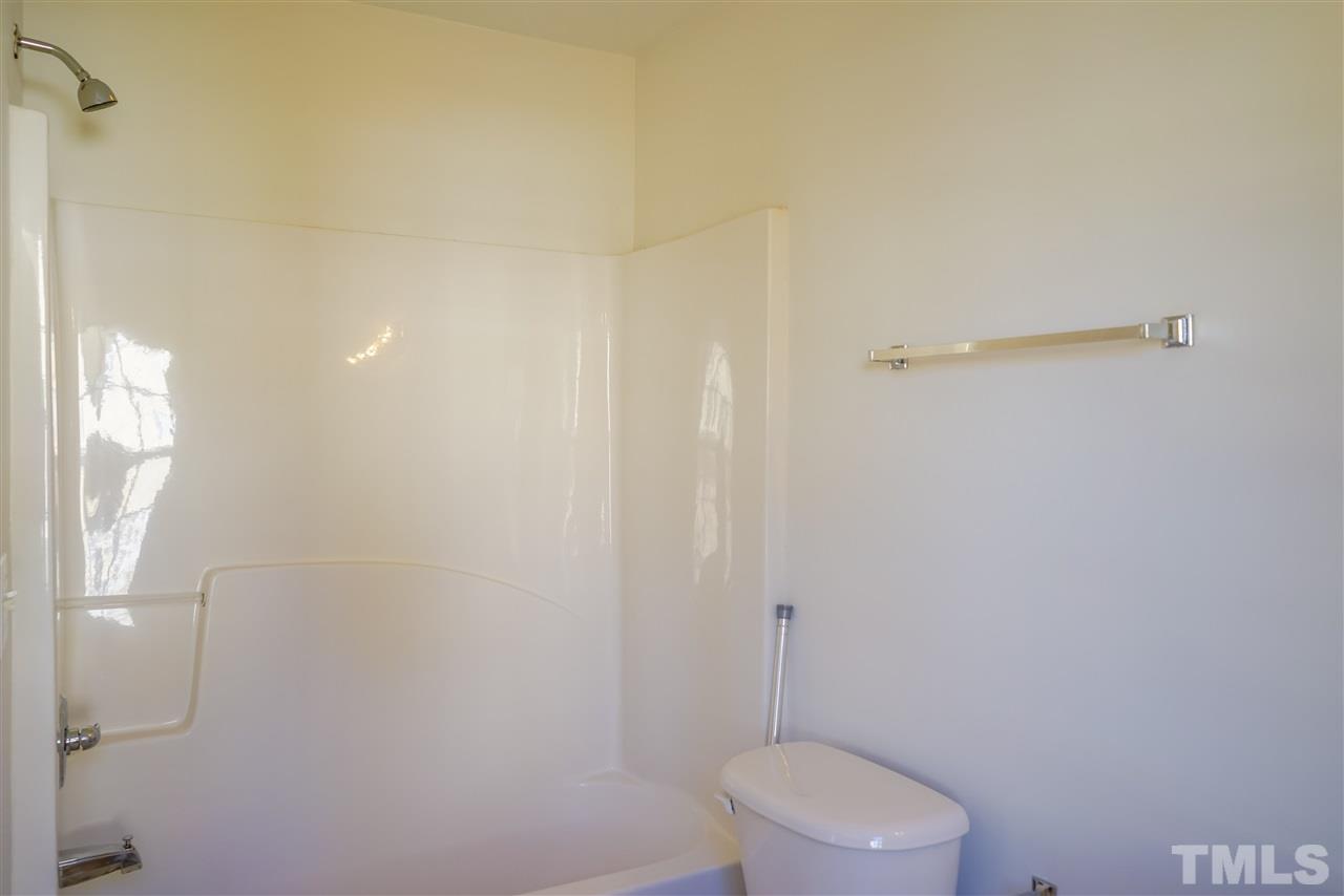 4232 Beacon Crest Way Raleigh, NC 27604 - Photo 19 of 25 a white toilet sitting next to a shower