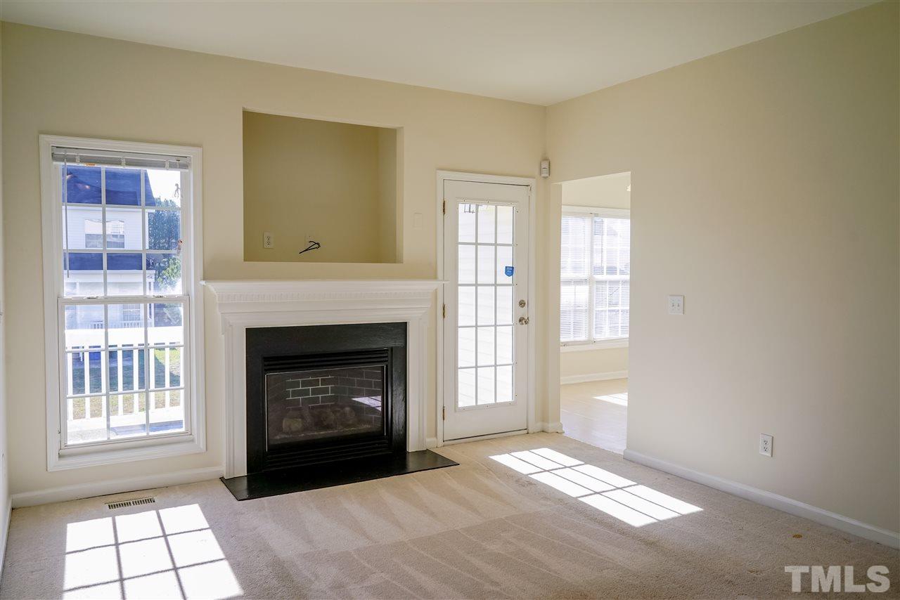4232 Beacon Crest Way Raleigh, NC 27604 - Photo 4 of 25 a view of an empty room with window and fire place