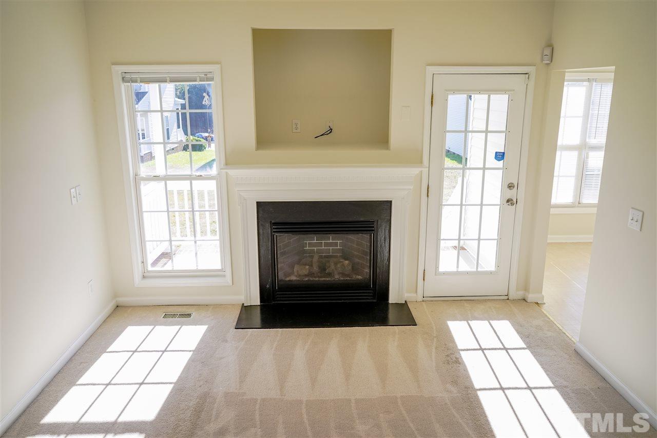 4232 Beacon Crest Way Raleigh, NC 27604 - Photo 6 of 25 an empty room with windows and fireplace