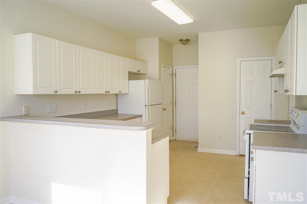 4232 Beacon Crest Way Raleigh, NC 27604 - Photo 9 of 25 a kitchen with stainless steel appliances a refrigerator and a stove
