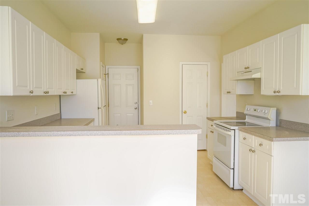 4232 Beacon Crest Way Raleigh, NC 27604 - Photo 10 of 25 a kitchen with stainless steel appliances granite countertop a sink and a stove