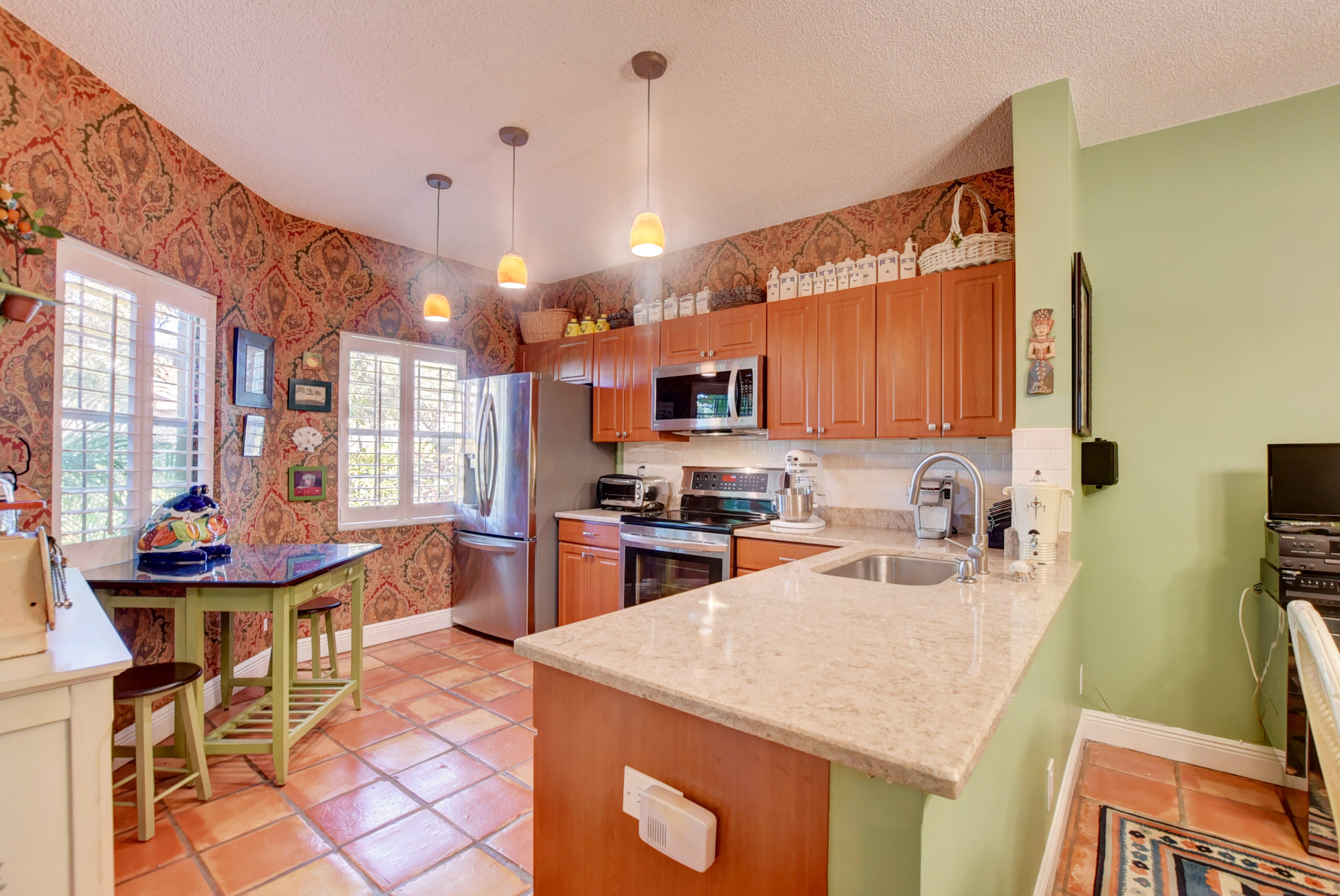 6660 Via Regina Boca Raton, FL 33433 - Photo 11 of 28 a kitchen with a sink a stove and chairs