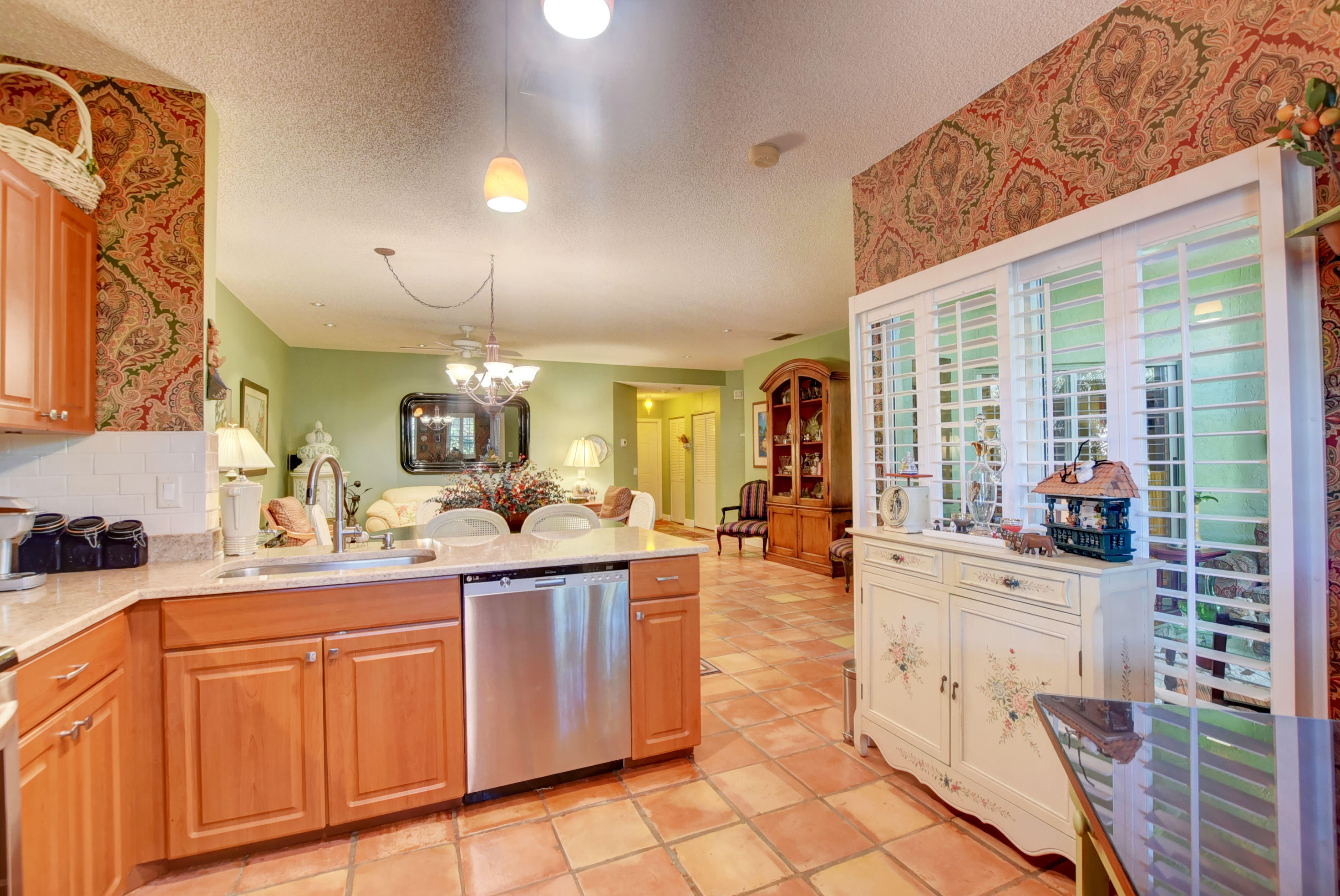 6660 Via Regina Boca Raton, FL 33433 - Photo 13 of 28 a kitchen with stainless steel appliances granite countertop a sink and cabinets