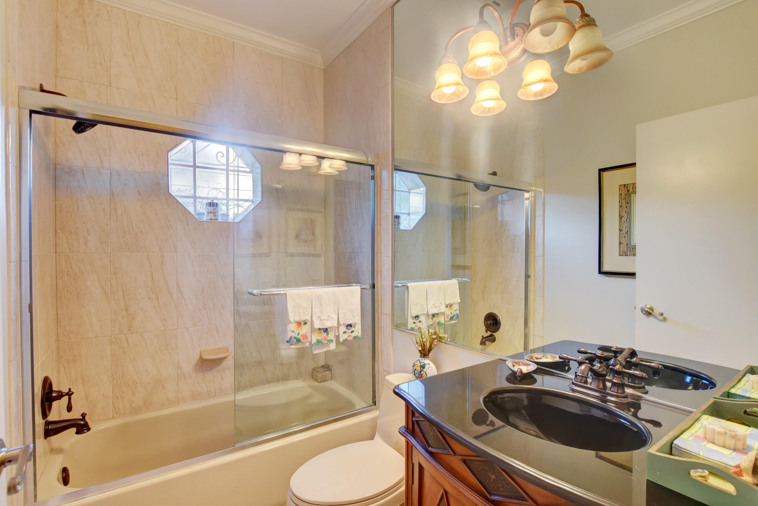6660 Via Regina Boca Raton, FL 33433 - Photo 24 of 28 a bathroom with a sink a mirror a bathtub and shower