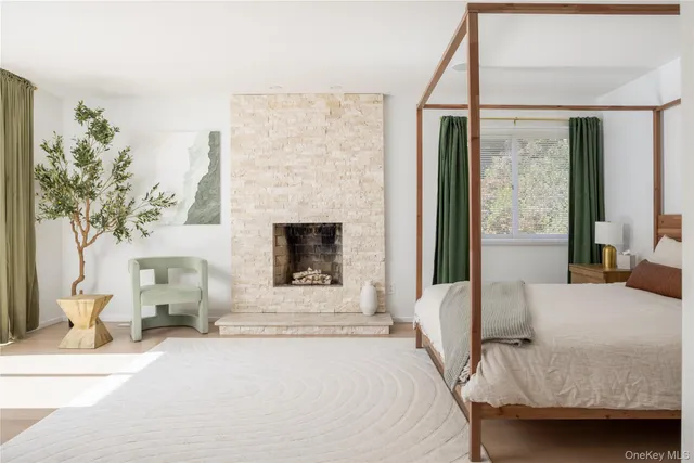 a bedroom with a bed and a fireplace