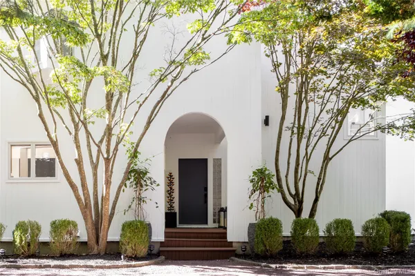 a front view of a house with garden