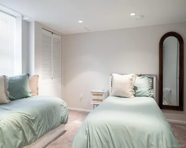 a bedroom with a large bed and a window