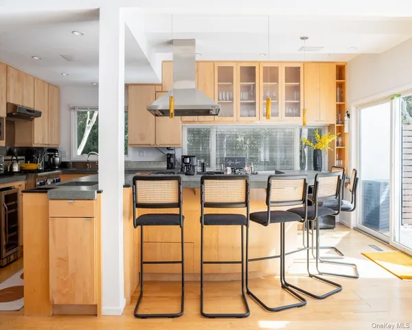 a kitchen with granite countertop a stove and white cabinets